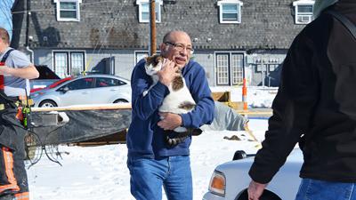 Cutline: Dennis Sanchez recovered his cat, Lucy. She was unhurt, but frightened and hiding in the apartment. When asked if he had any comment, Sanchez stated that the “local fire department is great!”