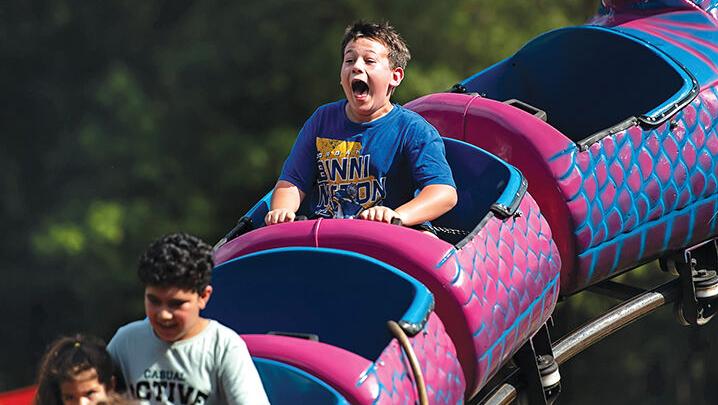 Ryder James, 12, yells out during his turn on the roller coaster during the 2025 Arnold Days celebration.