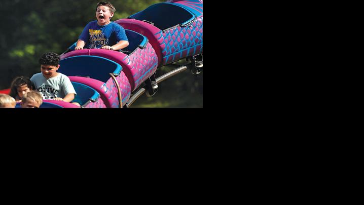 Ryder James, 12, yells out during his turn on the roller coaster during the 2025 Arnold Days celebration.