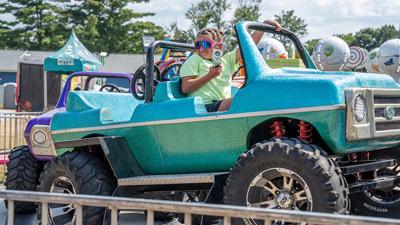 Arianna Evans, 6, of Festus goes for a ride at the county fair.