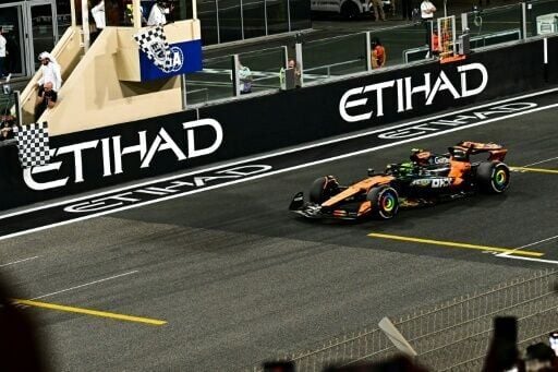 Lando Norris crosses the line in Abu Dhabi to become McLaren's first world champion since Lewis Hamilton in 2008