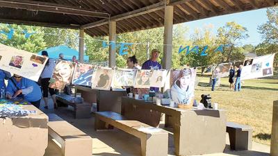 Participants display posters of loved ones at the walk.