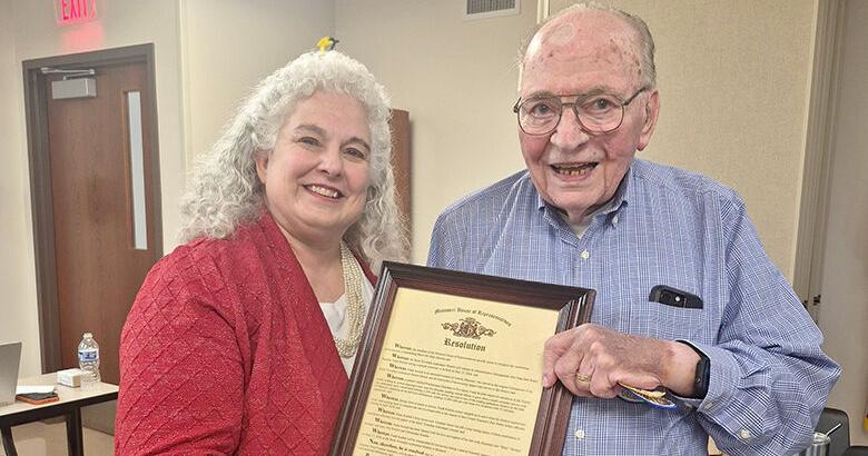 State Rep. Renee Reuter, left, hands Frank Kutilek a resolution from the Missouri House of Representatives on May 27, when the Rock Township Ambulance District named its House 4 after him.