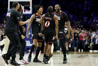 Andre Drummond celebrates a three-pointer with Philadelphia 76ers teammates Tyrese Maxey and Kelly Oubre Jr. during the Sixers' NBA play-in victory over the Orlando Magic