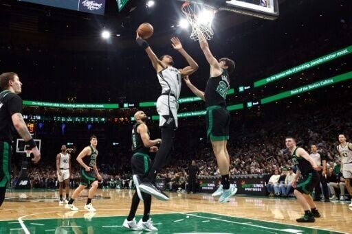 San Antonio's Victor Wembanyama rises for a dunk over Hugo Gonzalez in the Spurs' NBA victory over the Boston Celtics