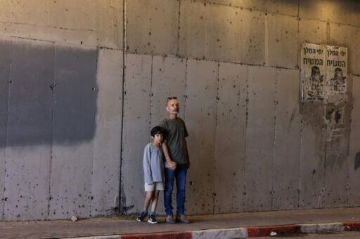 A man and a child shelter inside a tunnel near Abu Ghosh, near Jerusalem, on March 28