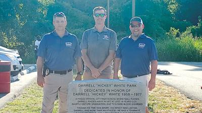 From left are Crystal City Police Chief Chad Helms, Mayor Mike Osher and City Administrator Jason Eisenbeis at the revealing of the monument for Hickey White Park.
