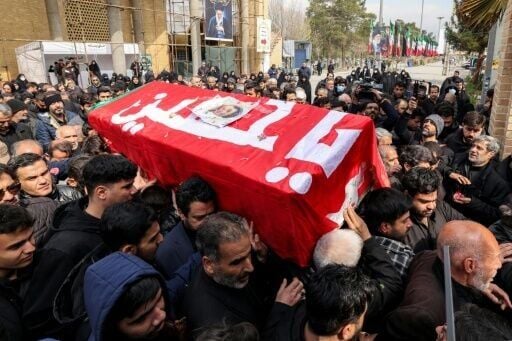 Mourners carry the casket of a person killed in recent US-Israeli airstrikes during the burial at a cemetery on the southern outskirts of Tehran on March 9