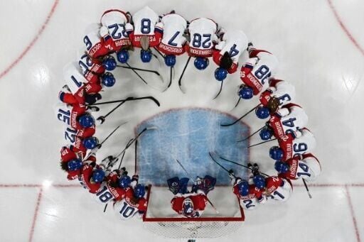 Czech Republic's women ice hockey players gather in a huddle before their game against the USA at the Winter Olympics