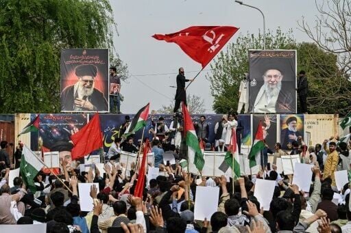 Shia Muslims holding portraits of Iran's slain supreme leader Ayatollah Ali Khamenei take part in an anti US-Israel protest in Islamabad on March 6, 2026