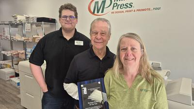 Minuteman Press owner Gary Slane, center, was named the Arnold Chamber of Commerce 2025 Business Person of the Year. Also pictured are graphic designer David Hollenberg and customer service representative Pam Wakefield.