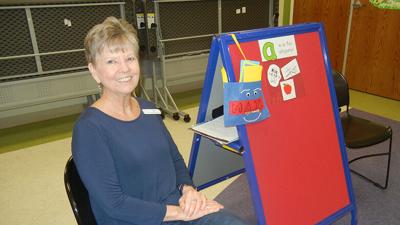 Carla Aubuchon prepares to conduct her final Storytime for a group of kids.