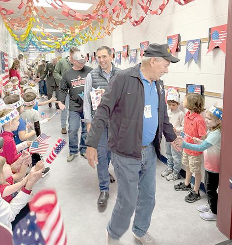 Veterans participate in an appreciation parade through Blevins Elementary.