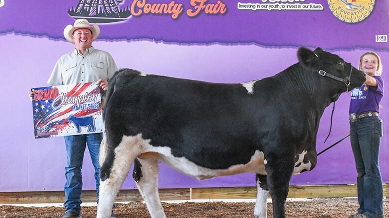 Paisley Epple, 13, of Hillsboro with her grand champion steer, which sold for $33,998.40.