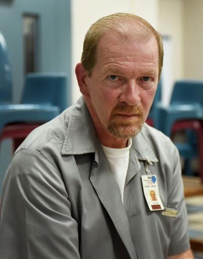 James Scott sits in a visitor room