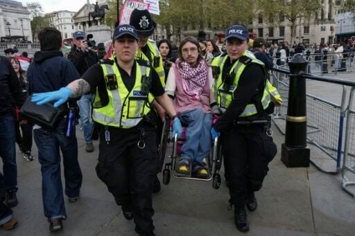 Officers carried away activists to cheers and clapping from other demonstrators at the sit-down demonstration