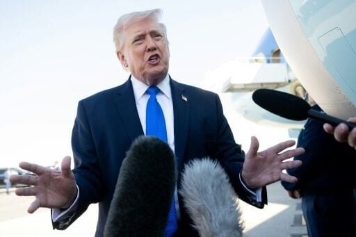 US President Donald Trump speaks to reporters before boarding Air Force One in Florida