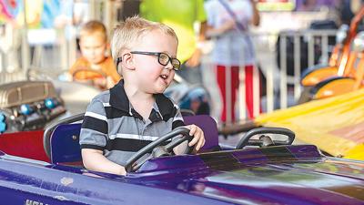 Landon Herman, then 4, of Arnold enjoys a ride at last year’s Immaculate Conception parish picnic. This year’s event is slated for  May 19-20.