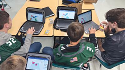 De Soto Junior High School students work to solve a puzzle on their computers.