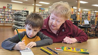Marilyn Parr with 4-year-old Camden Hartman of Festus, who visits the library regularly with his babysitter.