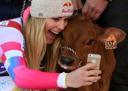 Lindsey Vonn takes a selfie with a calf on the podium after winning the Val d'Isere downhill in 2014