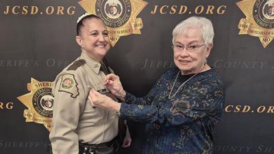 Jefferson County Sheriff’s Office Deputy Melissa Day, left, requested Jan Vessell, one of the Sheriff’s Office’s first female deputies, pin her 25-year star to her uniform on Jan. 7 at the Sheriff’s Office in Hillsboro.