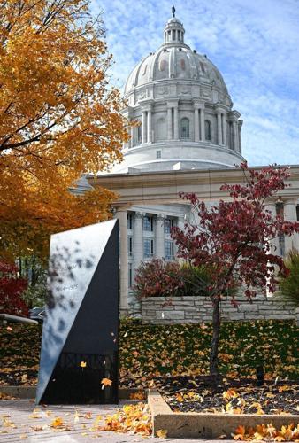 Leaves flutter around the Vietnam War obelisk at the Missouri Veterans Memorial on Tuesday