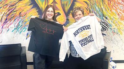 Erica Church, left, holds her 2022 CHD awareness shirt