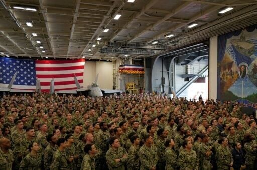 US Navy personnel look on during US President Donald Trump's visit to the USS George Washington aircraft carrier at the US naval base in Yokosuka