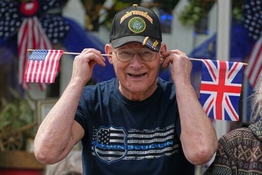 A royal fan waits for the arrival of King Charles and Queen Camilla in Front Royal, Virginia