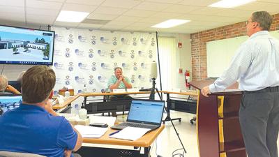 Jefferson County Health Department administrators and board members listen to Jim Huber of Archimages Inc. talk about plans for the agency’s new building in Hillsboro.