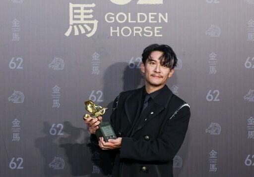 Taiwanese actor Chang Chen poses after winning best leading actor for the his role in 'Lucky Lu'