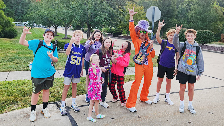 Students stand with a costumed Ben Heiser in September.