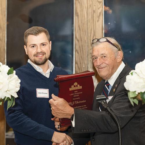 Danny Tuggle presents the 2024 Large Business Award to Amer Krvavac, representing the H-J Family of Companies.