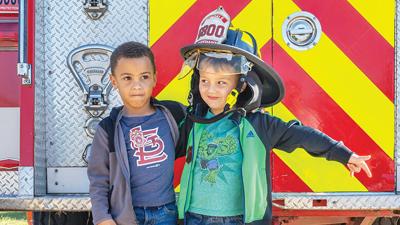 From left, Gerhardt Coleman and Anthony Null, then 5, check out the firetrucks at last year’s Fire Engine Rally.