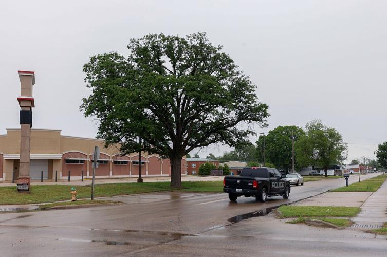 A Malden police car drives past a building
