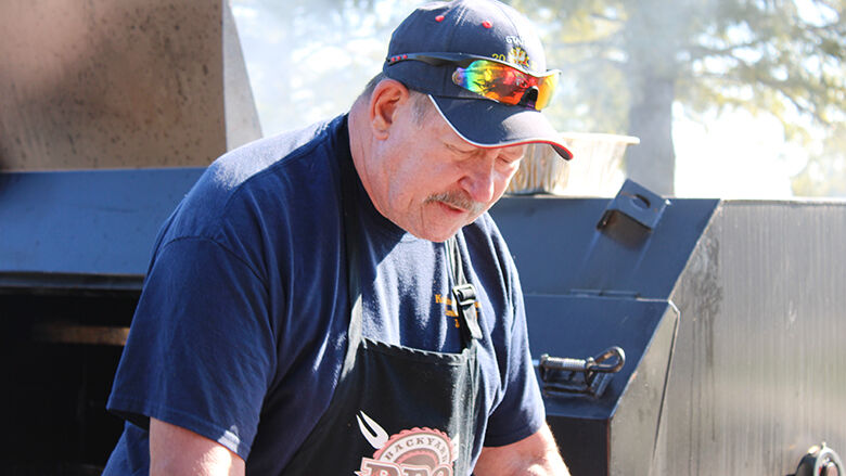 Jeff Berdahl works to prepare barbecued ribs during a Knights of Columbus fundraising event on Sept. 15.