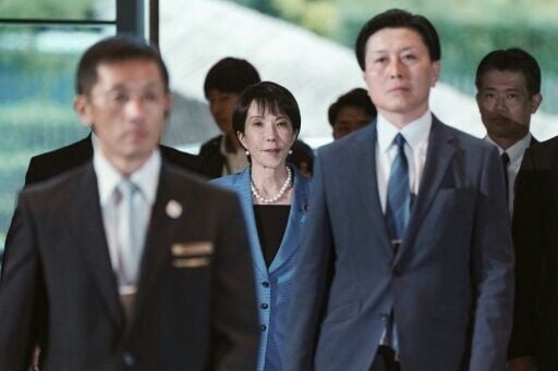 Japan's new Prime Minister Sanae Takaichi (C) arriving at the prime minister's office after being appointed by the parliament, in Tokyo