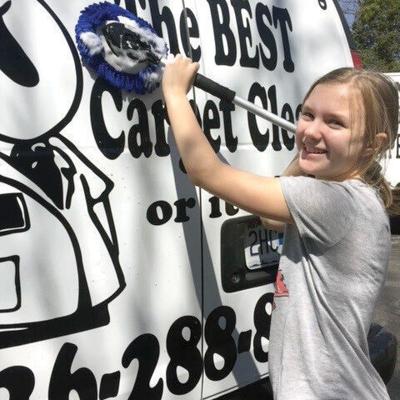 Hayden Mueller cleans a company van.
