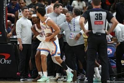 Oklahome City's Ajay Mitchell, center left, is pulled out of a melee of players following a second-quarter altercation with the Washington Wizards