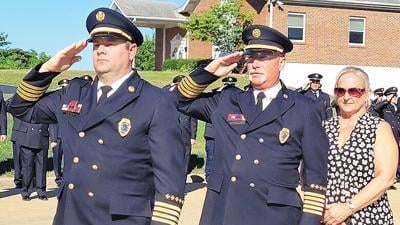 Interim Chief Kevin Wingbermuehle, left, and Chief Jeff Broombaugh, with his wife, Lisa.