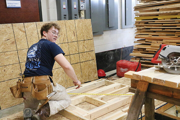 Kaleb Ward, a senior at Northwest High School, works on a small structure for the SkillsUSA district competition.