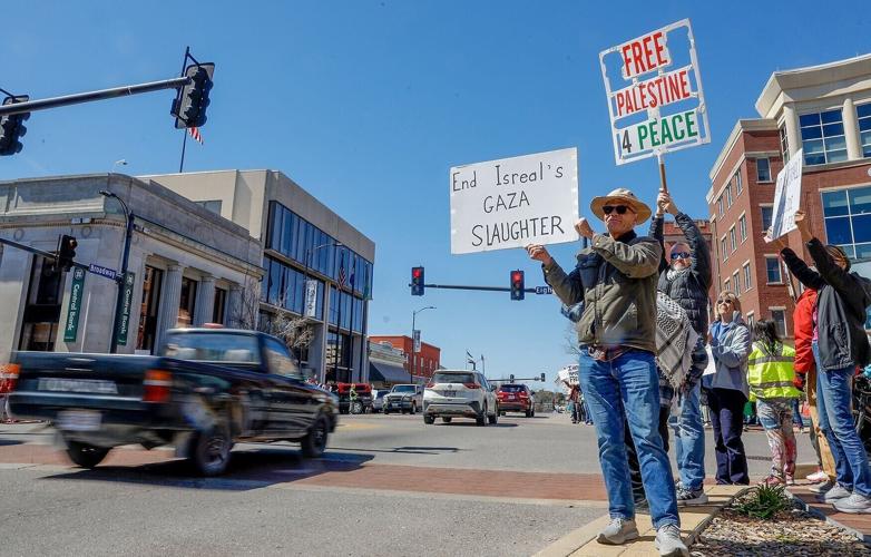 Mark Out holds a sign after the No Kings rally