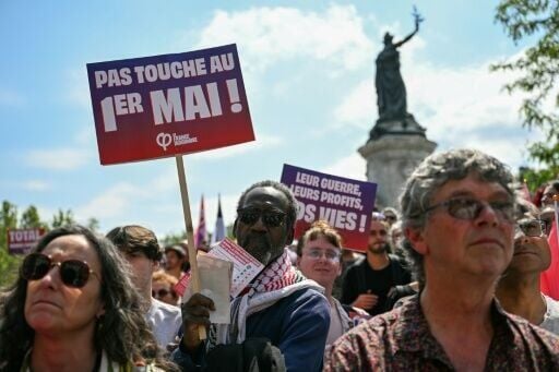 'Hands off May 1,' read the poster of a hard-left activist at a May Day protest in Paris