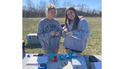 Fox High School rocketry team members Heidi Brockmann, left, and Paige Metcalf work on one of the team’s rockets.