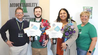 From left, De Soto School District Superintendent Ron Farrow, Seth and Samantha Harris and Beverly Wilson, Board of Education president.