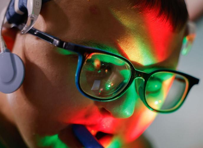 Carter McKee, 11, changes the colors of the lights from a DJ mixer toy