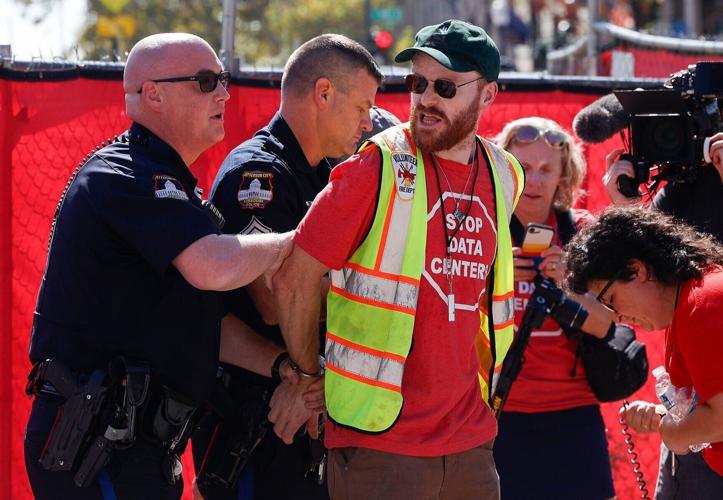 A protester named Russell is arrested at a rally
