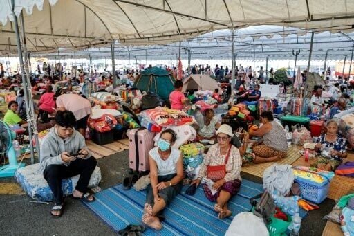 Evacuated Thai residents gather at a temporary shelter following clashes along the Thailand-Cambodia border in Buriram province