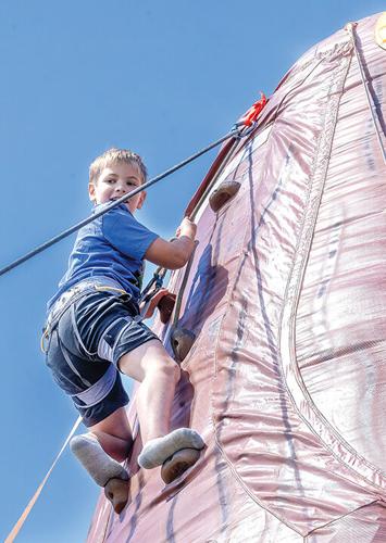 Grant Austermann, 8, of Festus climbs an inflatable rock wall at the First Baptist Church of Festus-Crystal City.